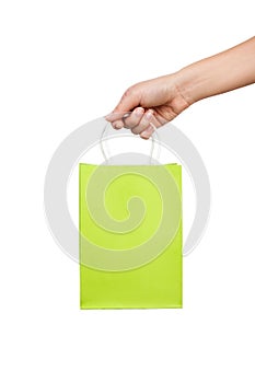 Woman hand holds a bright green bag for shopping isolated on white background