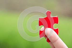 The woman hand holds a  jigsaw, the background is sunset, solutions and strategy Concep