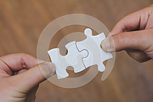 The woman hand holds a jigsaw, solutions and strategy Concep
