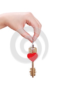 The woman hand holds a key to heart
