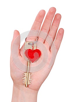 The woman hand holds a key to heart