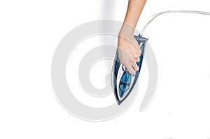 Woman hand ironing clothes top view on white background