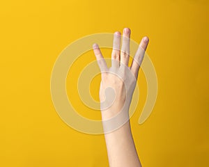 Woman hand isolated showing index, middle, ring and little four fingers