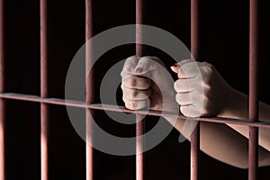 Woman hand in jail photo