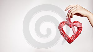 Woman Hand Keep Wooden Heart. Heart on White Background with Copy Space. Love, Family. Valentine`s Day concept.