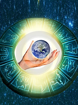 Woman hand keeping our planet Earth astrology concept