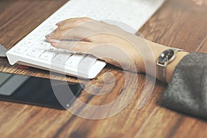 Woman hand keyboard and phone