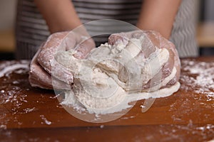 Woman Hand Kneaded Fresh Raw Dough on the Wooden Board