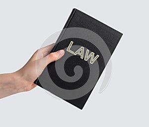 Woman hand with law book. Code, legal dictionary, guide. Education, studying information for becoming lawyer concept