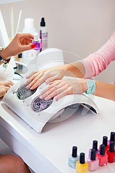 Woman hand on manicure treatment in beauty salon. Beauty parlour