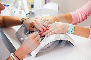Woman hand on manicure treatment in beauty salon. Beauty parlour