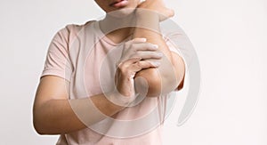 Woman hand massage physiotherapy elbow is sore and numb, exhausted, tingling. Guillain-Barre Syndrome, a side effect of the Covid-