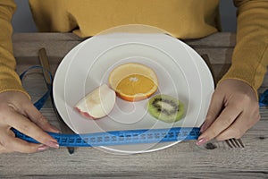 Woman  hand meter on plate