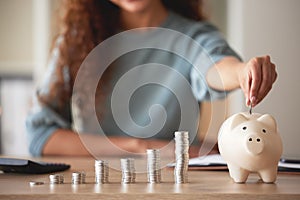 Woman, hand and money savings in piggy bank, finance and budget, future financial planning with investment and coins on