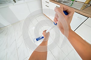 Woman Hand Mopping The Floor In Kitchen