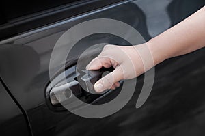 Woman hand open a car door,hand pulling a car`s door handle