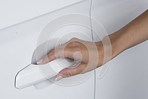 Woman hand on open the new white car door background