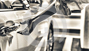 Woman hand opening car door inside a parking