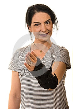 Woman with hand orthosis  stretch her palm