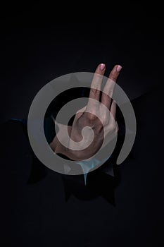 Woman hand over black isolated background showing 2 fingers