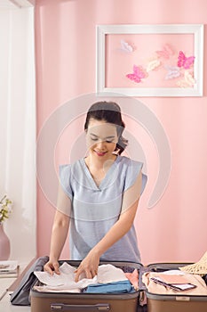 Woman hand packing a luggage for a new journey and travel for a long weekend