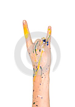 Woman hand in paint making sign of the horns (rockers)