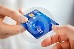 Woman hand passing credit card