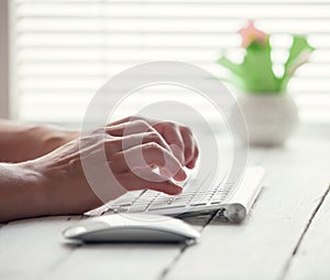 Woman hand on the PC keyboard