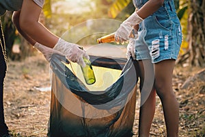 woman hand picking up garbage glass bottle for cleaning