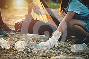 woman hand picking up garbage plastic bottle for cleaning