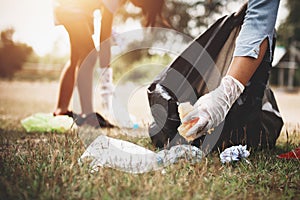 woman hand picking up garbage plastic for cleaning photo