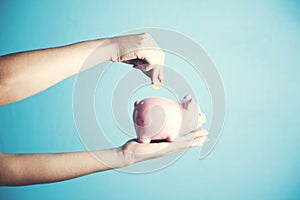 Woman hand piggy bank and coin