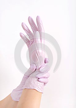 Woman hand in pink glove , copy space light