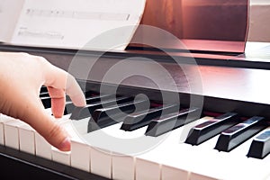 Woman hand playing piano. Music and art background. Back side vi