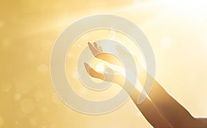 Woman hand praying for blessing from god on sunset photo