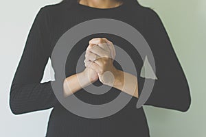 Woman with hand in praying position,Female prayer hands clasped together