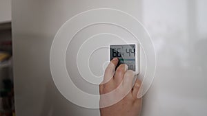 Woman hand press button activate smart home system at home. Female use modern security equipment or alarm control panel