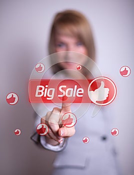 Woman hand pressing BIG SALE button