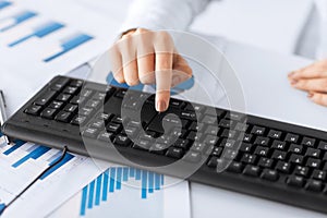 Woman hand pressing enter button on keyboard