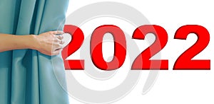 Woman hand pulling blue velvet curtain with presenting 2022 new year sign. Loading year 2022. Concept Start New Year 2022