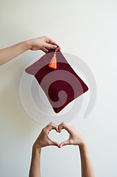 Woman hand with purse on white background, close-up