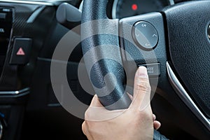 A woman hand pushes the mode hold control button