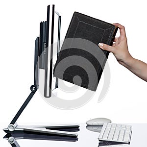 Woman hand put book in computer display