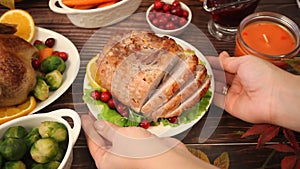 Woman hand put on the table traditional sliced honey glazed ham for festive Christmas or Thanksgiving day.