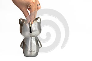 Woman hand putting money coin into money box