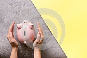 woman hand putting money coin into piggy for saving money wealth and financial concept