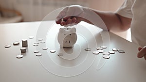 woman hand putting money coin into piggy for saving money wealth and financial concept.