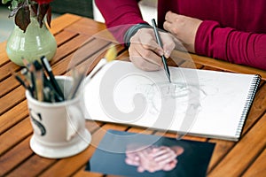 Woman hand rawing in pencil from photo