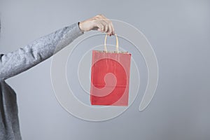 Woman hand red shopping bag