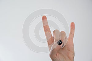 woman hand in rock and roll gesture sign